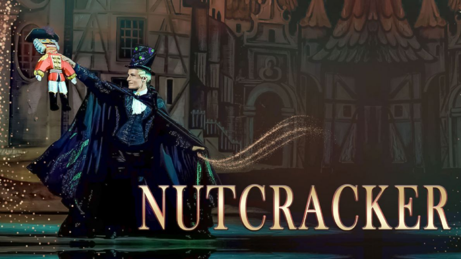 man in black cape and tophat holding up a stuffed nutcracker with a medieval village behind him