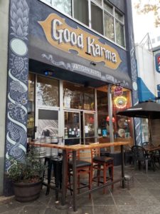 Front of good karma artisan ales & cafe with small dining patio