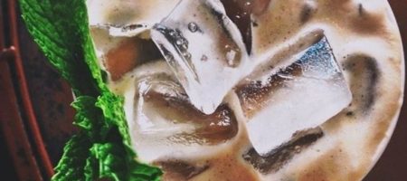 Iced coffee with mint leaf as garnish