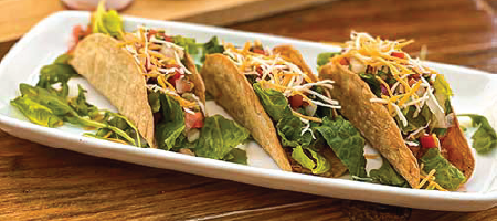 3 hard shelled tacos on a plate from Food & Beverages Restaurant