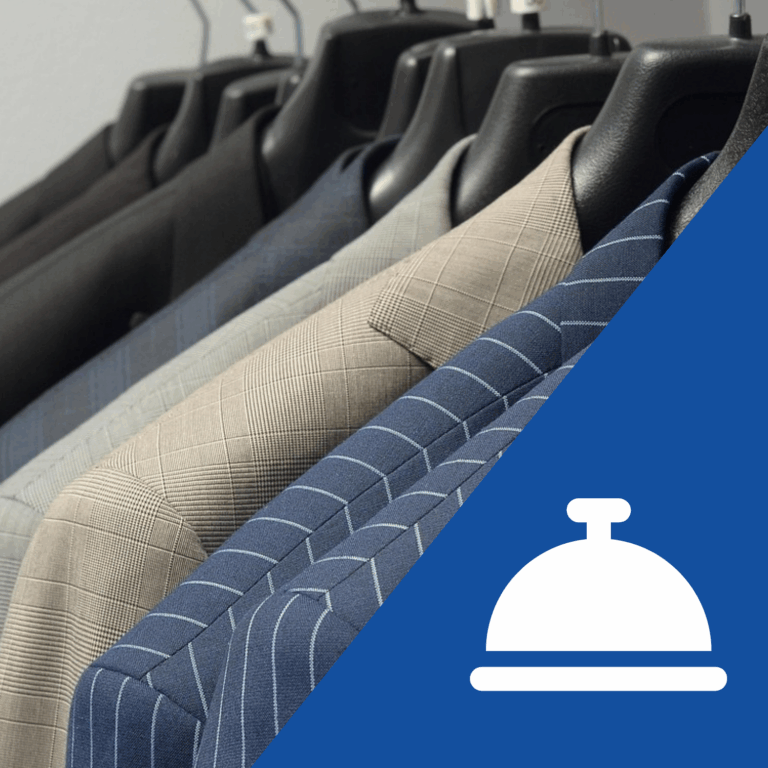 A closeup of a rack of suit jackets. In the right corner is an icon of a bell